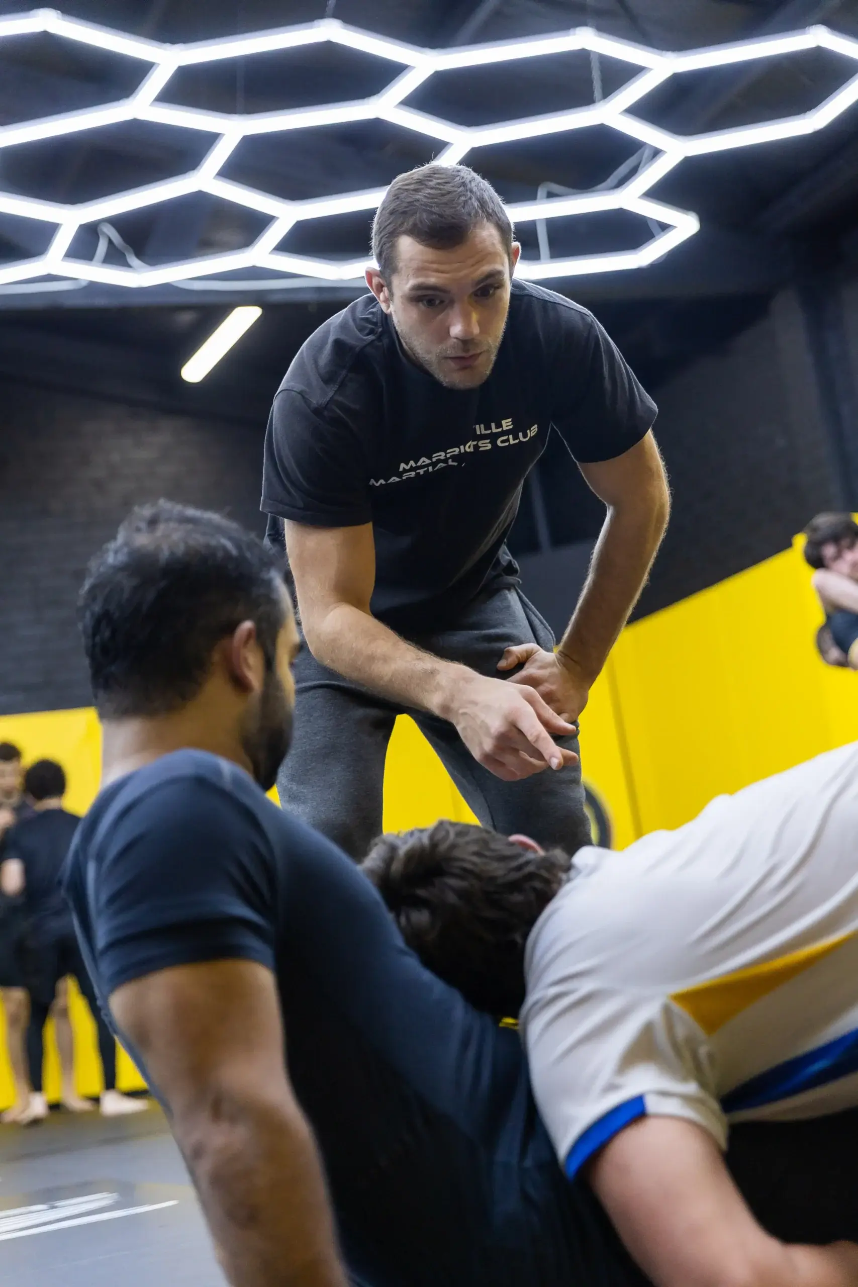 A coach guiding a grappling drill at Marrickville Martial Arts Club
